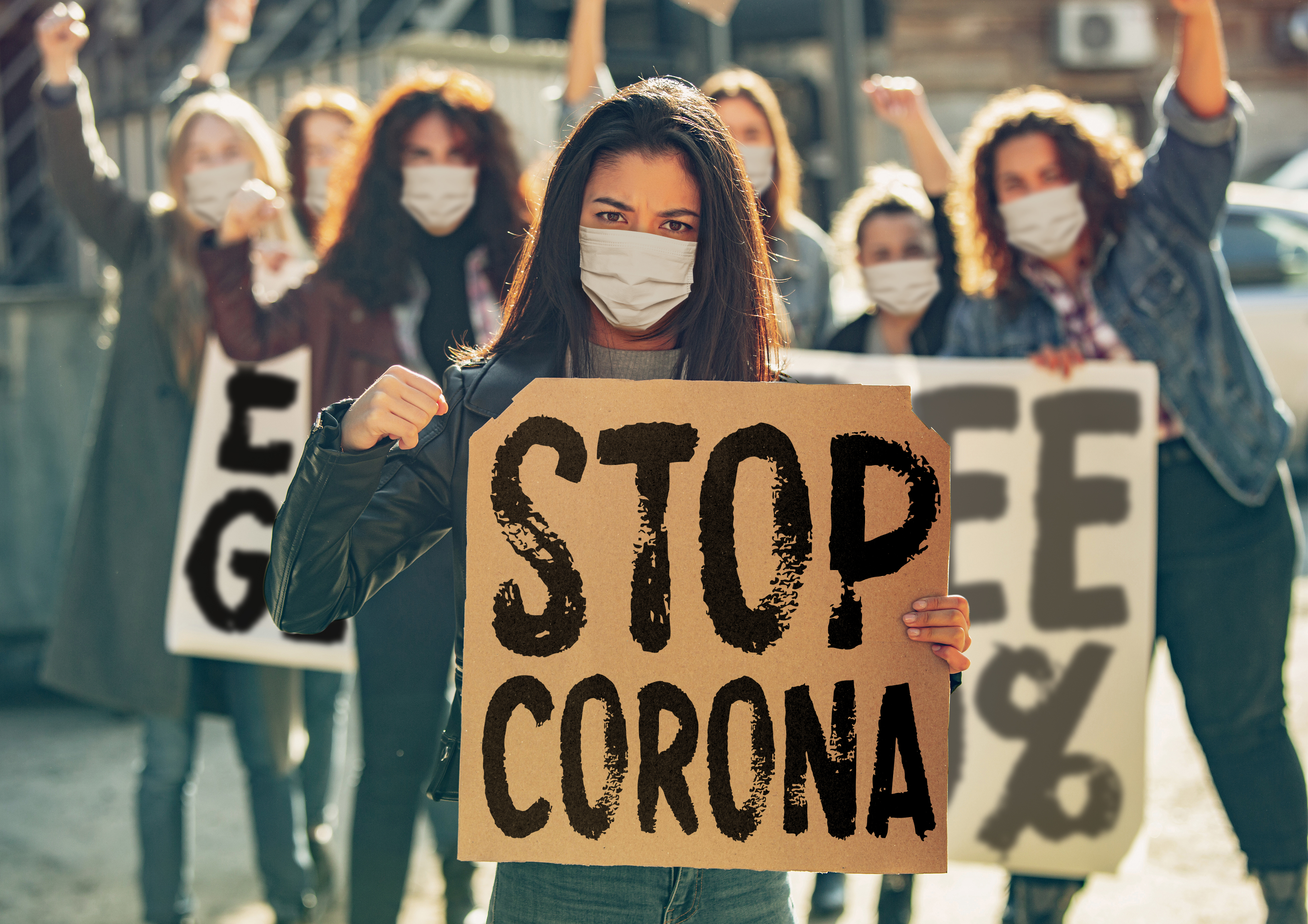 Corona demonstration with sign saying "stop corona"