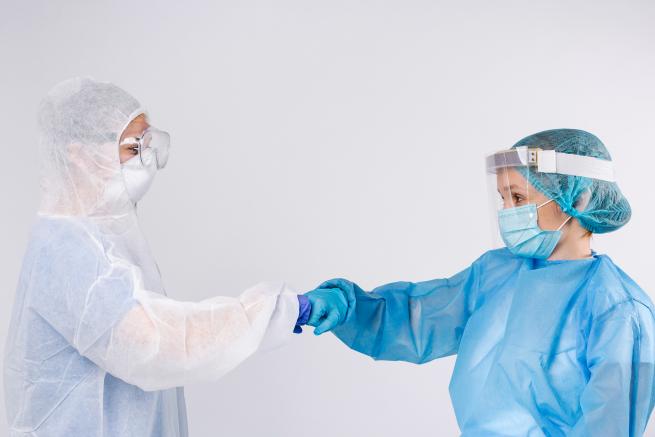 Two people wearing personal prottective epuipment (PPE)