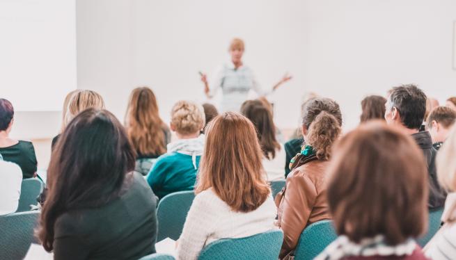 A person presenting their work in front of an audience.