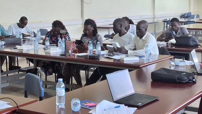 A community-based research team working in a class roomin the Acholi subregion