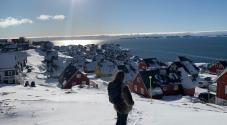 Student looking at Nuuk city from a hill 